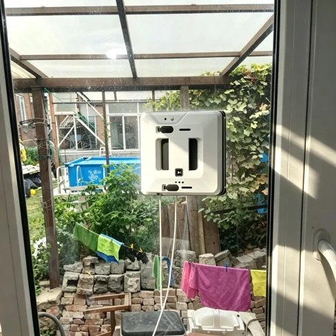 Family using a smart window cleaning robot at home